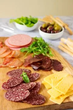 Appetizer table for wine or beer with sausages, dried meat and cheese, served Stock Photos