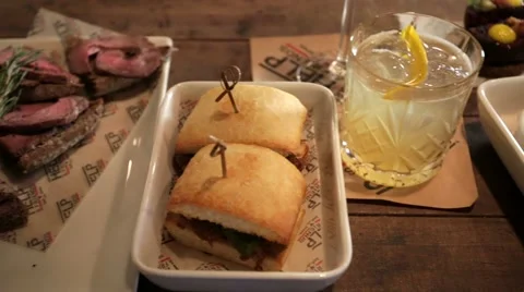 Appetizers for cocktails on a table, Mr. Help &amp; Friends bar. Stock Footage 60620533