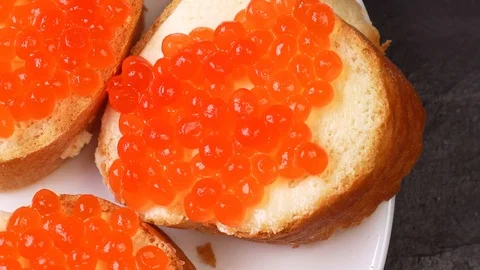 Appetizers with red caviar close up rotate on a plate Stock Footage 122254149