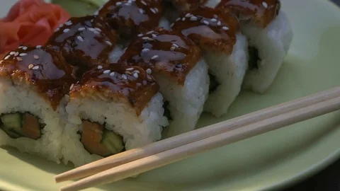 Appetizing amazing "Dragon" square sushi rolls with eel, salmon, cucumber, nori Stock Footage 75034951