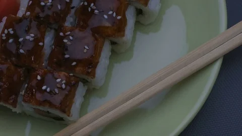 Appetizing amazing "Dragon" square sushi rolls with eel, salmon, cucumber, nori Stock Footage 75196397