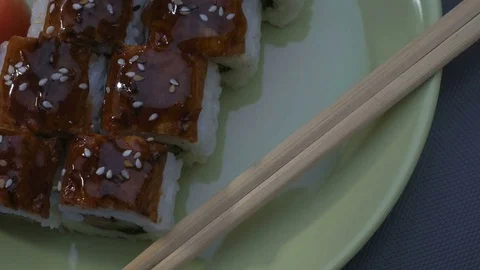 Appetizing amazing "Dragon" square sushi rolls with eel, salmon, cucumber, nori Stock Footage 75197288