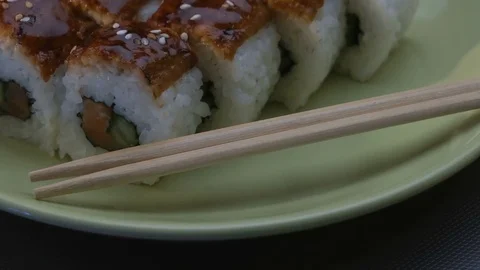 Appetizing amazing "Dragon" square sushi rolls with eel, salmon, cucumber, nori Video stock 75202004