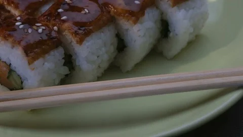 Appetizing amazing "Dragon" square sushi rolls with eel, salmon, cucumber, nori Stockbeeldmateriaal 75202419