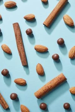 Appetizing background made from almonds, chocolate balls and cinnamon sticks on Stock-Fotos