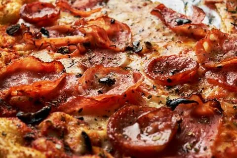 Appetizing background pepperoni pizza with bacon closeup of filling the frame Foto stock