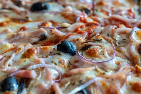 Appetizing background pepperoni pizza closeup filling the frame. Stock Photos