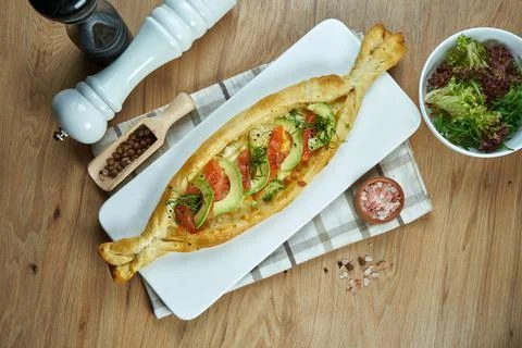 Appetizing baked open pie with salted suluguni cheese, salmon and avocado on  Stock Photos