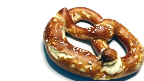 Appetizing bavarian pretzel on white, rotating video Stock Footage 235536116