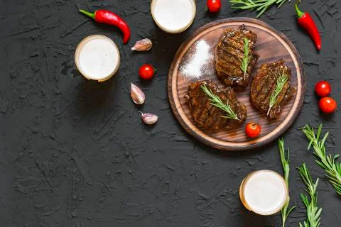 Appetizing beef steaks, beer and rosemary 写真素材