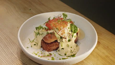 Appetizing benedict egg sandwich with salmon red caviar hollandaise sauce Video stock 151295330