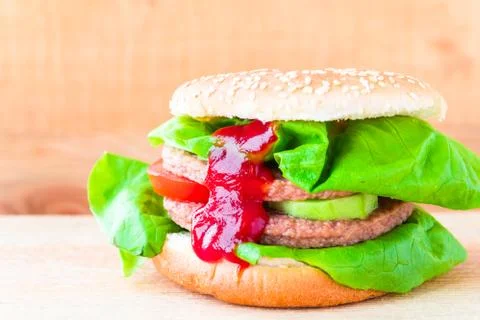 Appetizing big cheeseburger fresh lettuce cucumber Stock Photos