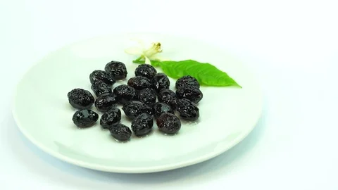 Appetizing black olives in white plate on white background. Rustic style. Stock Footage 88453898