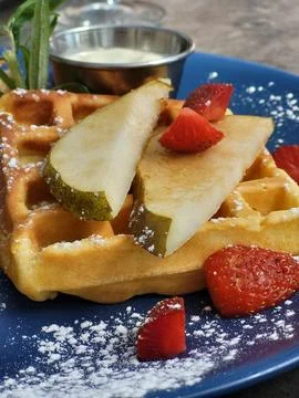 Appetizing breakfast in the form of a Belgian waffle with fruit Stock Photos