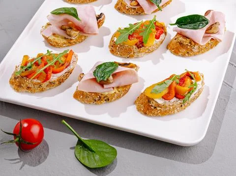 Appetizing bruschettas and canapes serving creative party finger food 스톡 사진