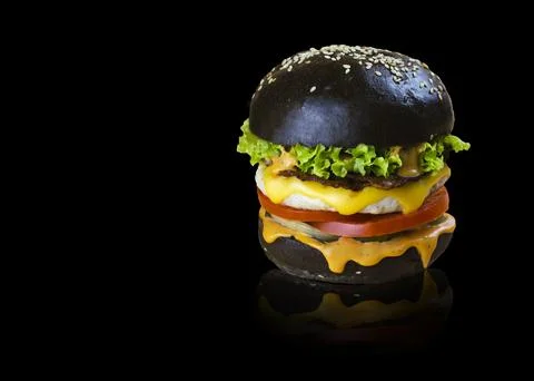 Appetizing burger on a black background Stock Photos