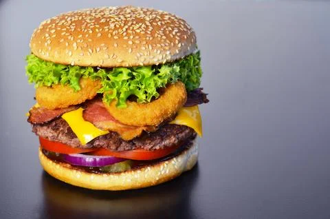 Appetizing burger on a black background Stock Photos