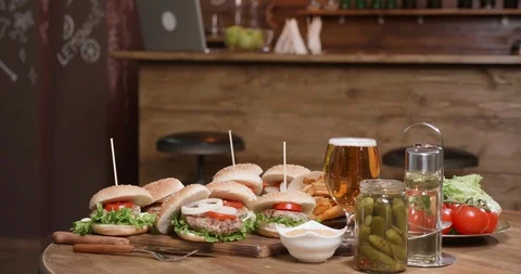 Appetizing burgers on a table in a small pub Stock Footage 104252840