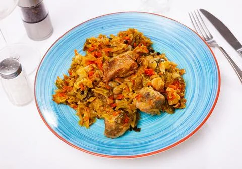 Appetizing cabbage stewed with pork meat on plate Stock Photos