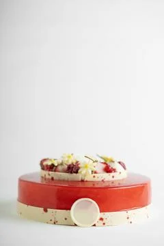 An appetizing cake displayed on a red and white striped cake stand, ready t.. Stock Photos