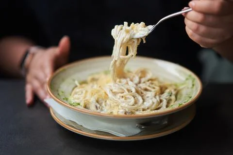 Appetizing carbonara paste with chicken improperly wound on fork. Spaghetti Stock Photos