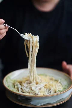 Appetizing carbonara paste with chicken improperly wound on fork. Spaghetti Stock Photos