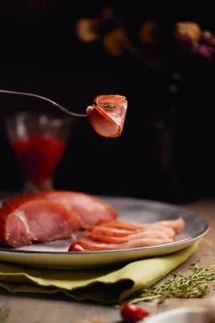 Appetizing carpaccio slice wrapped on a fork on dark background. Trend Food Stock Photos