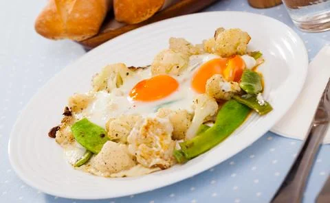 Appetizing cauliflower fried eggs for breakfast Stock Photos