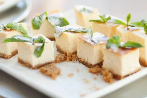Appetizing cheesecake with mint leaves. Stock Photos