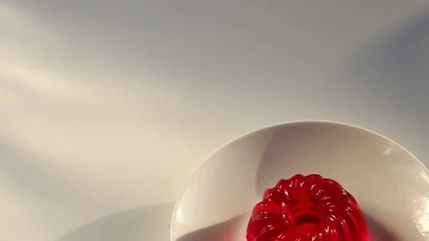 Appetizing cherry jelly on a white plate . slow motion Stock Footage 72585362