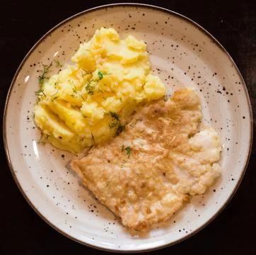 Appetizing chicken breasts in batter with mashed potatoes on plate Stock Photos