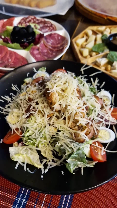 Appetizing Chicken Caesar Salad with Quail Eggs and Parmesan Stock Footage 326203276