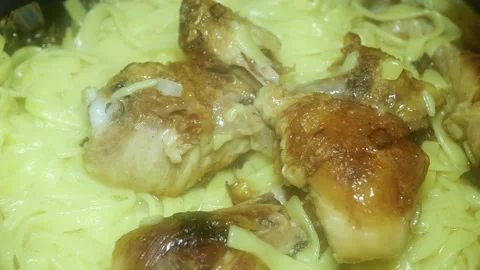 Appetizing chicken drumsticks with crust and noodles 스톡 동영상 230779486