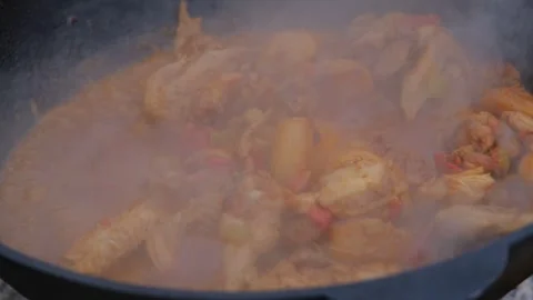 Appetizing chicken fried in a slow motion cauldron. Juicy chicken in a cauldron Stock Footage 279271921