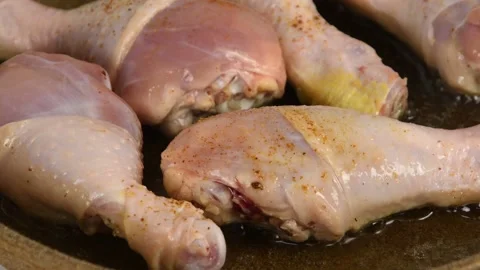 Appetizing chicken legs fried in a pan, sprinkled with spices Stock Footage 132349187
