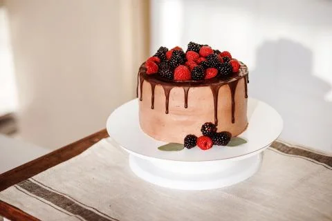 Appetizing chocolate cake with berries on the top. Cake for birthday or wedding Stock Photos
