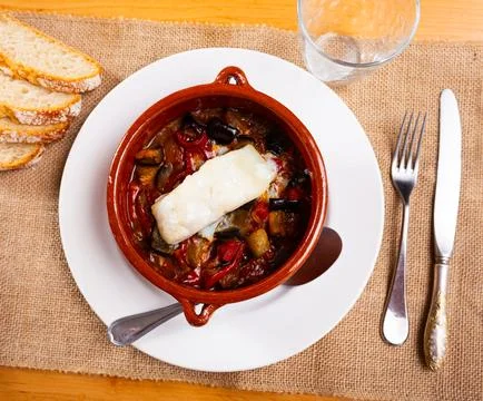 Appetizing cod served with samfaina vegetables Stock Photos
