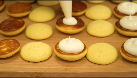 Appetizing cookies poured with cream Stock Footage 154909090