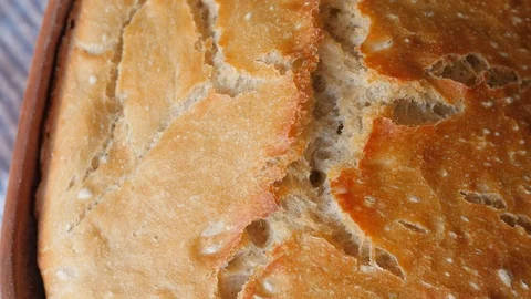 Appetizing cracked crust of bread rotating Stock Footage 87219641