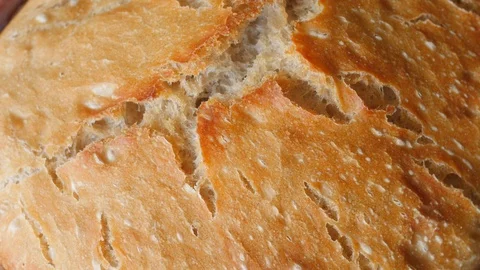 Appetizing cracked crust of bread rotating Stock Footage 87219695