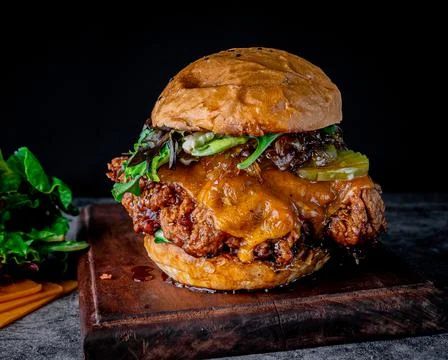 Appetizing crispy chicken burger on a plank Stock Photos