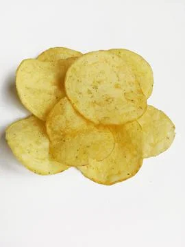 Appetizing crispy potato chips on white background Stock Photos