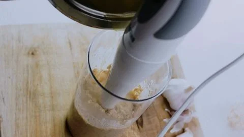 Appetizing culinary presentation: mixing spices into creamy walnut sauce Stock Photos