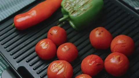 Appetizing culinary view of green pepper and red chili roasting beside tomatoes Stock Footage 342152694