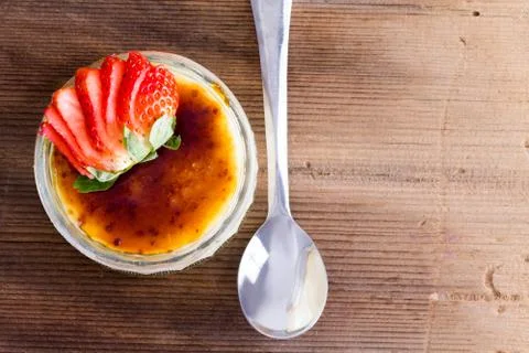 Appetizing custard with sliced strawberry Stock Photos