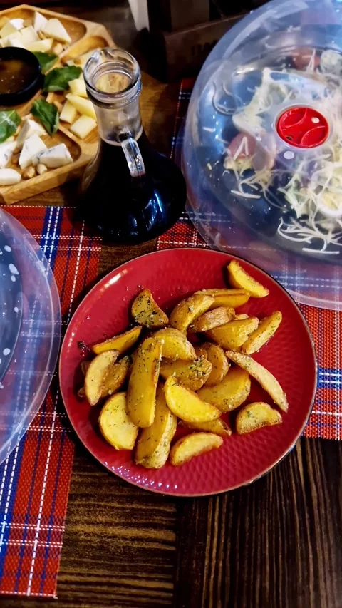 Appetizing Dinner Spread with Potato Wedges and Cheese Board Video stock 326202720