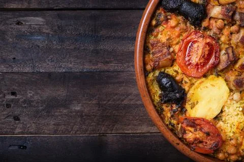 Appetizing earthenware casserole with baked rice, tomato, potato, chickpeas Stock Photos