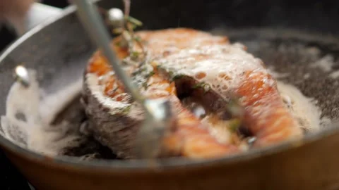 Appetizing fish steak is fried in a pan. fish is deliciously fried. salmon steak Stock Footage 158242079