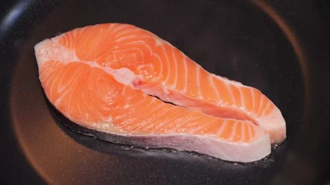 Appetizing fish steak is fried in a pan. Healthy food concept. Seafood. Stock Footage 314333383