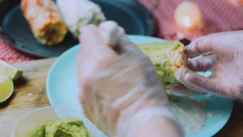 Appetizing food study: rolling corn in crumbled cheese Stock Footage 342172009